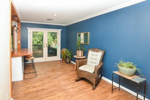1466 Wilson Ave, Saginaw, MI 48638 - sitting room featuring wood finished floors, crown molding, baseboards, and french doors