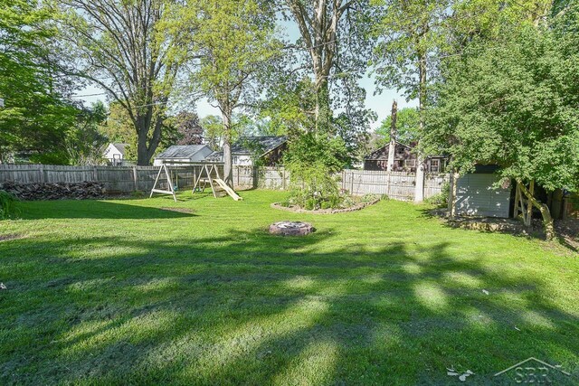 1466 Wilson Ave, Saginaw, MI 48638 - view of yard with a playground