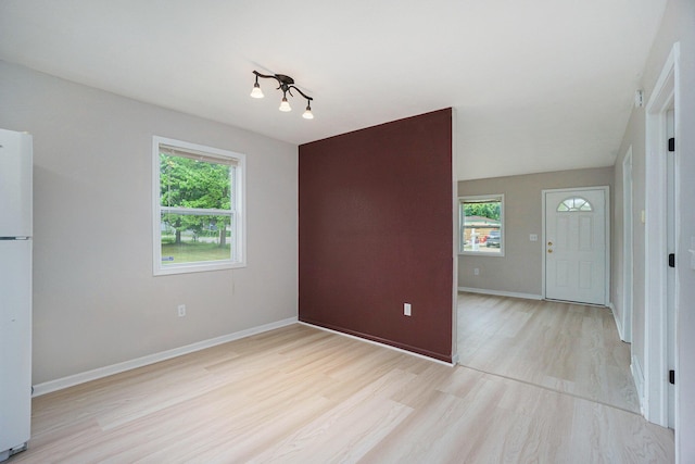 604 W Hill St, Plainwell, MI 49080 - unfurnished dining area featuring light wood finished floors, healthy amount of natural light, and baseboards