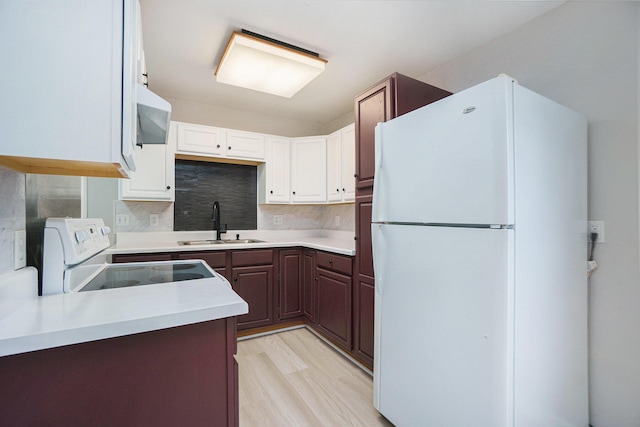 604 W Hill St, Plainwell, MI 49080 - kitchen featuring freestanding refrigerator, a sink, range with electric cooktop, light countertops, and decorative backsplash