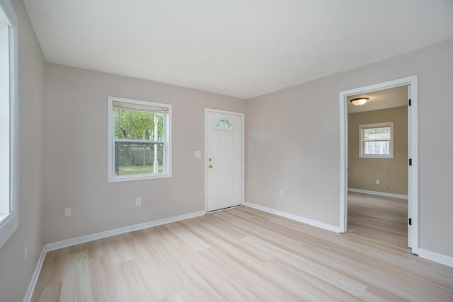 604 W Hill St, Plainwell, MI 49080 - entrance foyer with light wood finished floors, healthy amount of natural light, and baseboards
