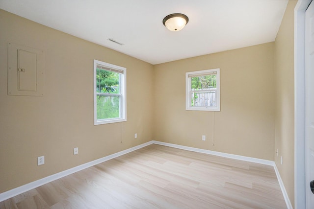 604 W Hill St, Plainwell, MI 49080 - spare room with light wood finished floors, electric panel, and baseboards