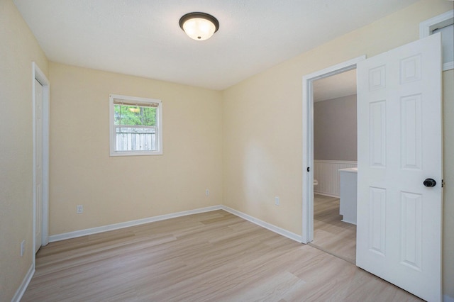 604 W Hill St, Plainwell, MI 49080 - unfurnished bedroom with light wood finished floors and baseboards