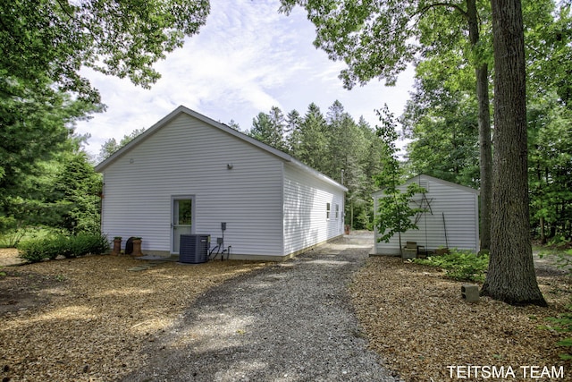 12993 144th Ave, Grand Haven, MI 49417 - view of home's exterior with cooling unit and an outbuilding