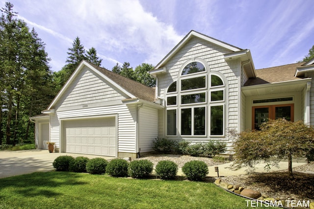 12993 144th Ave, Grand Haven, MI 49417 - view of front facade featuring a garage, concrete driveway, a front lawn, and roof with shingles