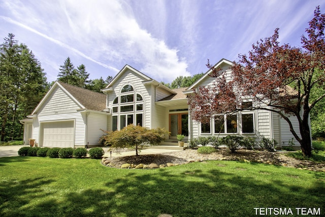 12993 144th Ave, Grand Haven, MI 49417 - view of front of property with an attached garage, a front yard, driveway, and roof with shingles