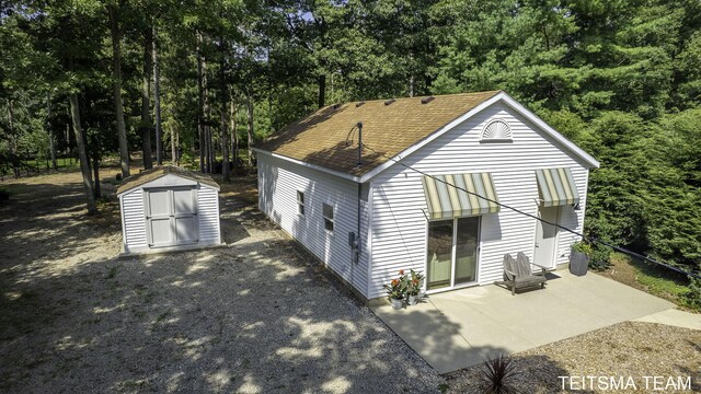 12993 144th Ave, Grand Haven, MI 49417 - back of property with a patio area and roof with shingles