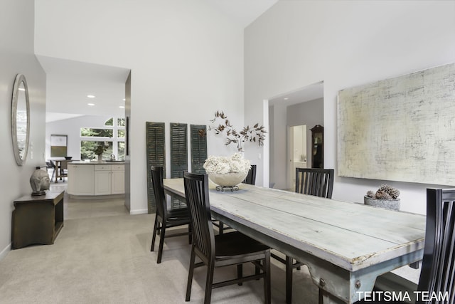 12993 144th Ave, Grand Haven, MI 49417 - dining space with light carpet, baseboards, high vaulted ceiling, and recessed lighting