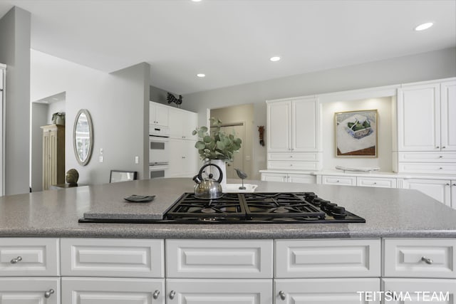 12993 144th Ave, Grand Haven, MI 49417 - kitchen with black gas cooktop, a center island, white cabinets, and recessed lighting