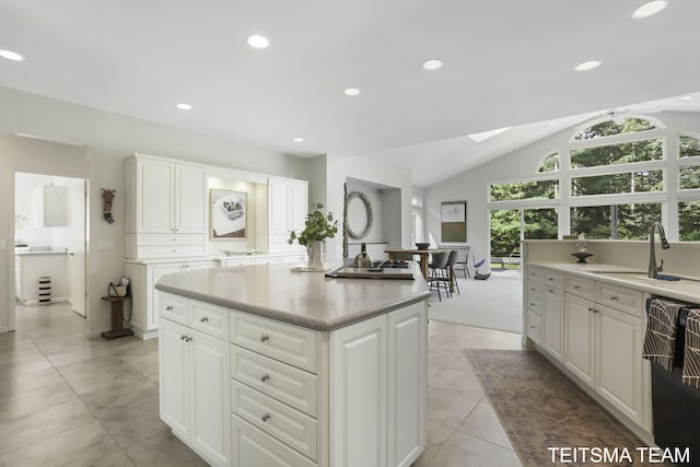 12993 144th Ave, Grand Haven, MI 49417 - kitchen with a sink, a skylight, a center island, recessed lighting, and white cabinetry