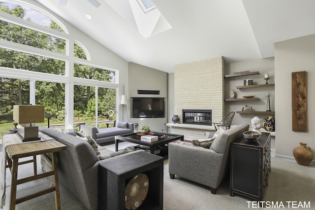 12993 144th Ave, Grand Haven, MI 49417 - living room with a skylight, high vaulted ceiling, light carpet, a brick fireplace, and a ceiling fan