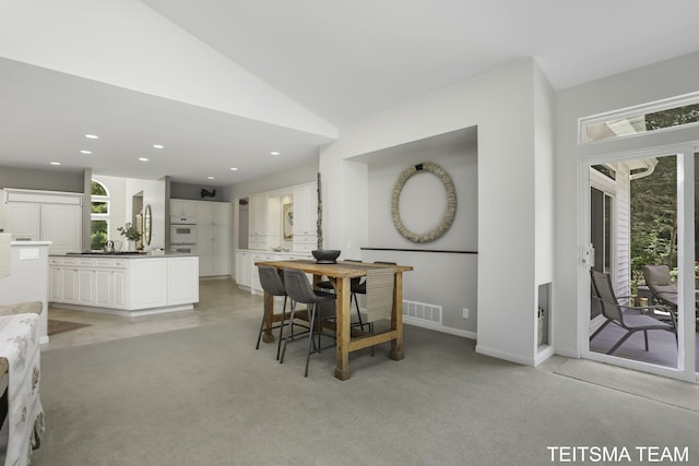 12993 144th Ave, Grand Haven, MI 49417 - dining space featuring light colored carpet, baseboards, lofted ceiling, and recessed lighting