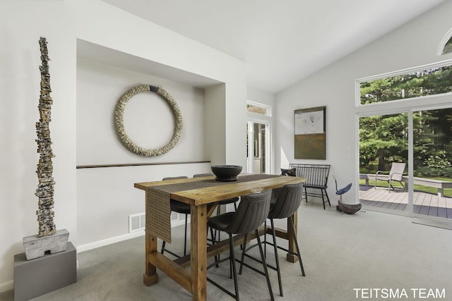 12993 144th Ave, Grand Haven, MI 49417 - dining room with carpet floors, vaulted ceiling, and baseboards