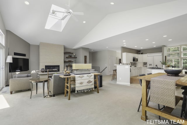12993 144th Ave, Grand Haven, MI 49417 - living room with light carpet, a ceiling fan, recessed lighting, a large fireplace, and high vaulted ceiling