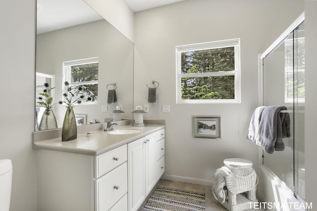 12993 144th Ave, Grand Haven, MI 49417 - bathroom featuring vanity, toilet, baseboards, and tile patterned flooring