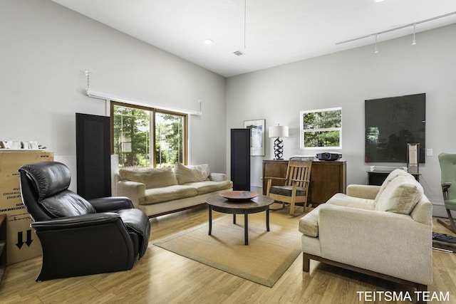 12993 144th Ave, Grand Haven, MI 49417 - living room with light wood-style flooring, attic access, and a high ceiling