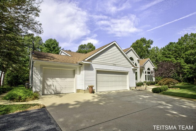 12993 144th Ave, Grand Haven, MI 49417 - ranch-style home with driveway, a garage, and a shingled roof