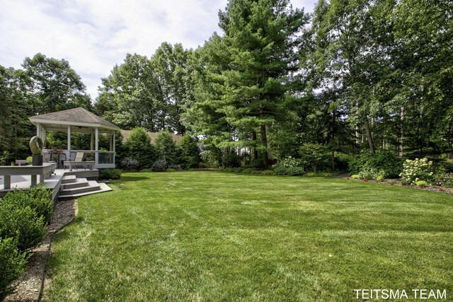 12993 144th Ave, Grand Haven, MI 49417 - view of grassy yard featuring a gazebo and view of wooded area