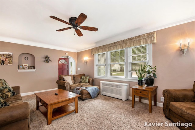 429 Van Allen St SE, Wyoming, MI 49548 - living area featuring radiator heating unit, ceiling fan, crown molding, arched walkways, and baseboards