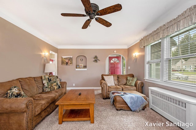 429 Van Allen St SE, Wyoming, MI 49548 - carpeted living room with radiator, healthy amount of natural light, a ceiling fan, crown molding, and arched walkways