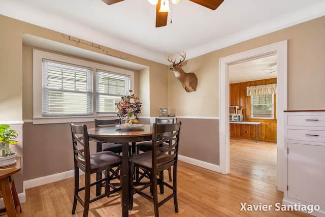 429 Van Allen St SE, Wyoming, MI 49548 - dining room featuring a ceiling fan, light wood-style flooring, and baseboards