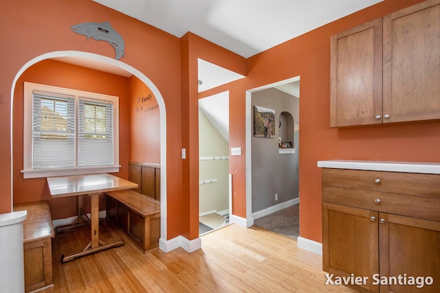 429 Van Allen St SE, Wyoming, MI 49548 - hallway with arched walkways, light wood-style flooring, and baseboards