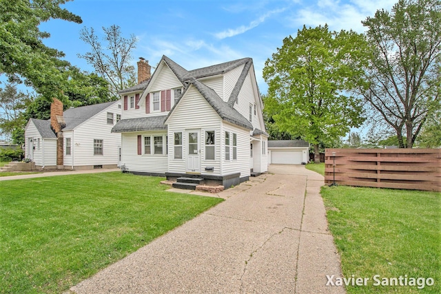 429 Van Allen St SE, Wyoming, MI 49548 - view of front facade with a chimney, roof with shingles, an outbuilding, and a detached garage