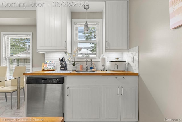 3346 Westpoint St, Dearborn, MI 48124 - kitchen with stainless steel dishwasher, butcher block countertops, a sink, decorative backsplash, and white cabinets