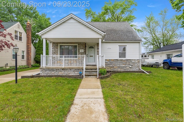 3346 Westpoint St, Dearborn, MI 48124 - bungalow with stone siding, covered porch, a front lawn, and roof with shingles