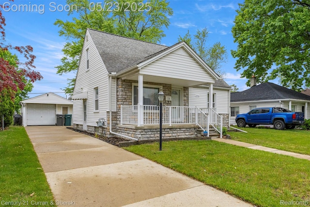 3346 Westpoint St, Dearborn, MI 48124 - view of front of home with stone siding, a shingled roof, covered porch, an outdoor structure, and concrete driveway