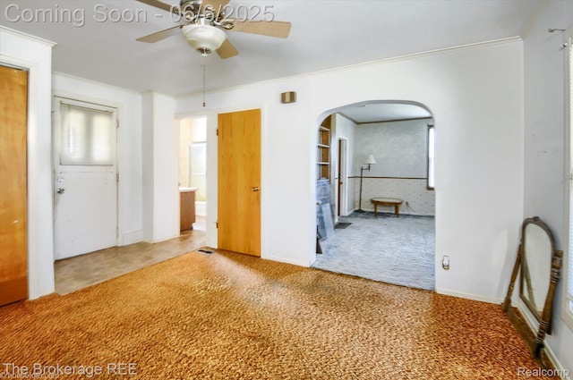 8114 Wilson Rd, Otisville, MI 48463 - unfurnished room featuring carpet, arched walkways, a ceiling fan, and crown molding
