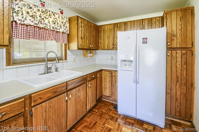 8114 Wilson Rd, Otisville, MI 48463 - kitchen with white fridge with ice dispenser, a sink, brown cabinets, tasteful backsplash, and light countertops