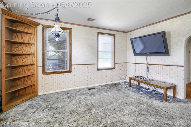 8114 Wilson Rd, Otisville, MI 48463 - carpeted living room featuring ornamental molding, wallpapered walls, and arched walkways