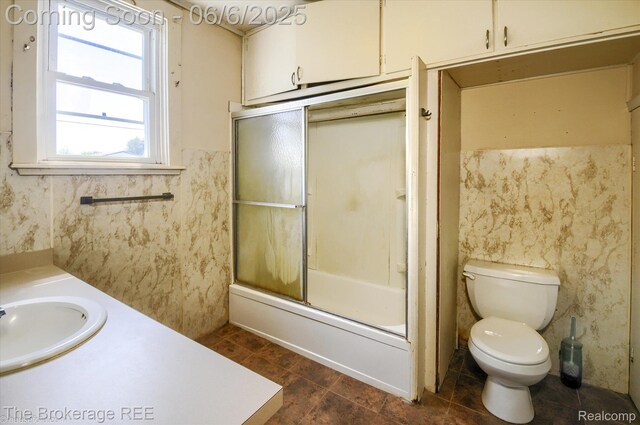 8114 Wilson Rd, Otisville, MI 48463 - full bathroom with toilet, combined bath / shower with glass door, vanity, and tile patterned floors