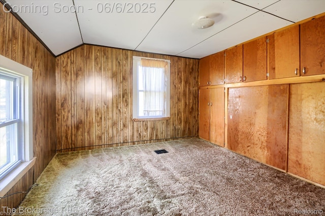 8114 Wilson Rd, Otisville, MI 48463 - empty room featuring lofted ceiling, carpet floors, and wood walls