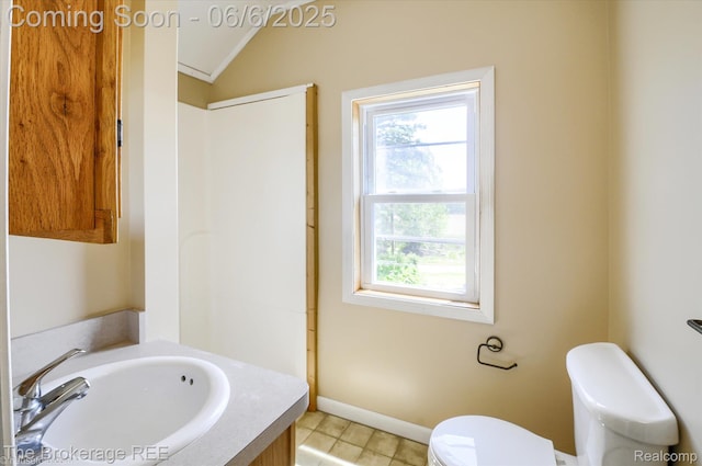 8114 Wilson Rd, Otisville, MI 48463 - bathroom with toilet, vanity, lofted ceiling, tile patterned flooring, and baseboards