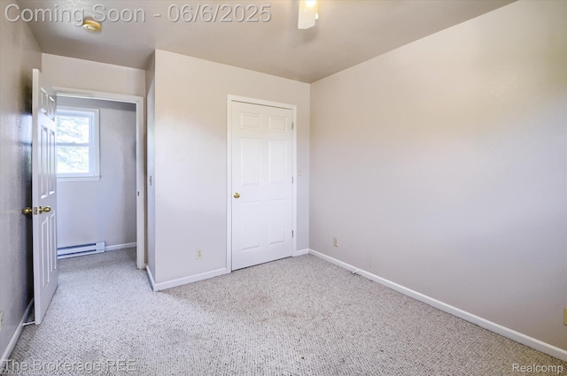 8114 Wilson Rd, Otisville, MI 48463 - unfurnished bedroom with baseboard heating, carpet flooring, baseboards, and a ceiling fan