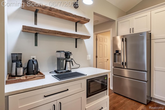 1542 Summerfield Ln, Howell, MI 48843 - kitchen featuring stainless steel refrigerator with ice dispenser, open shelves, black microwave, white cabinets, and wood finished floors
