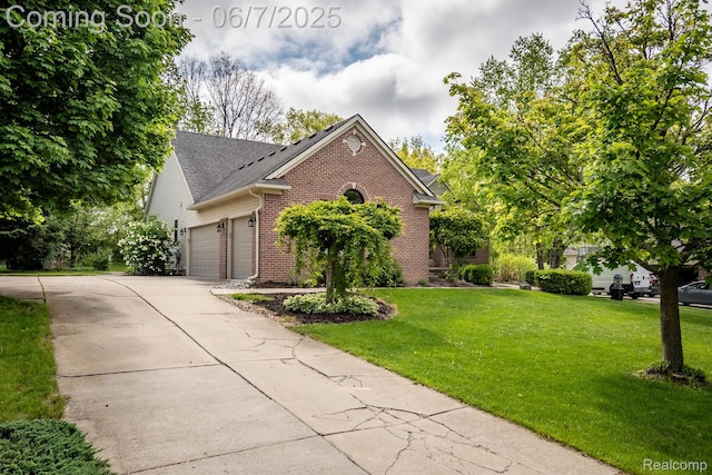 1542 Summerfield Ln, Howell, MI 48843 - view of front of house featuring brick siding, a garage, a front yard, and concrete driveway