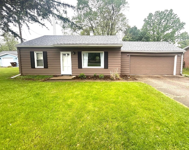 526 18th St, Jackson, MI 49203 - ranch-style house with asphalt driveway, an attached garage, a front yard, and a shingled roof