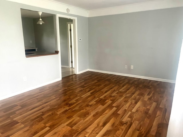 526 18th St, Jackson, MI 49203 - spare room with ornamental molding and dark wood-type flooring