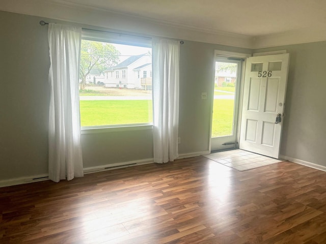 526 18th St, Jackson, MI 49203 - entrance foyer with wood finished floors, plenty of natural light, and crown molding