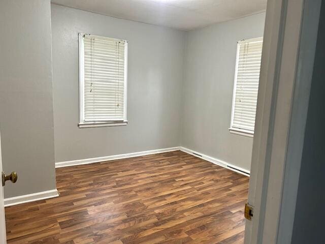 526 18th St, Jackson, MI 49203 - unfurnished room featuring dark wood finished floors and baseboards