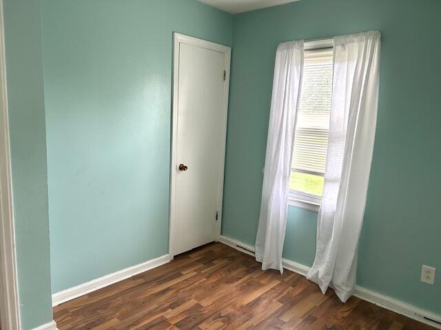 526 18th St, Jackson, MI 49203 - unfurnished room featuring dark wood-style flooring and baseboards