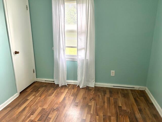 526 18th St, Jackson, MI 49203 - empty room featuring baseboards and dark wood-style flooring