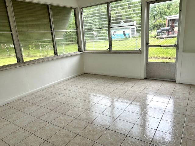 526 18th St, Jackson, MI 49203 - unfurnished sunroom featuring plenty of natural light