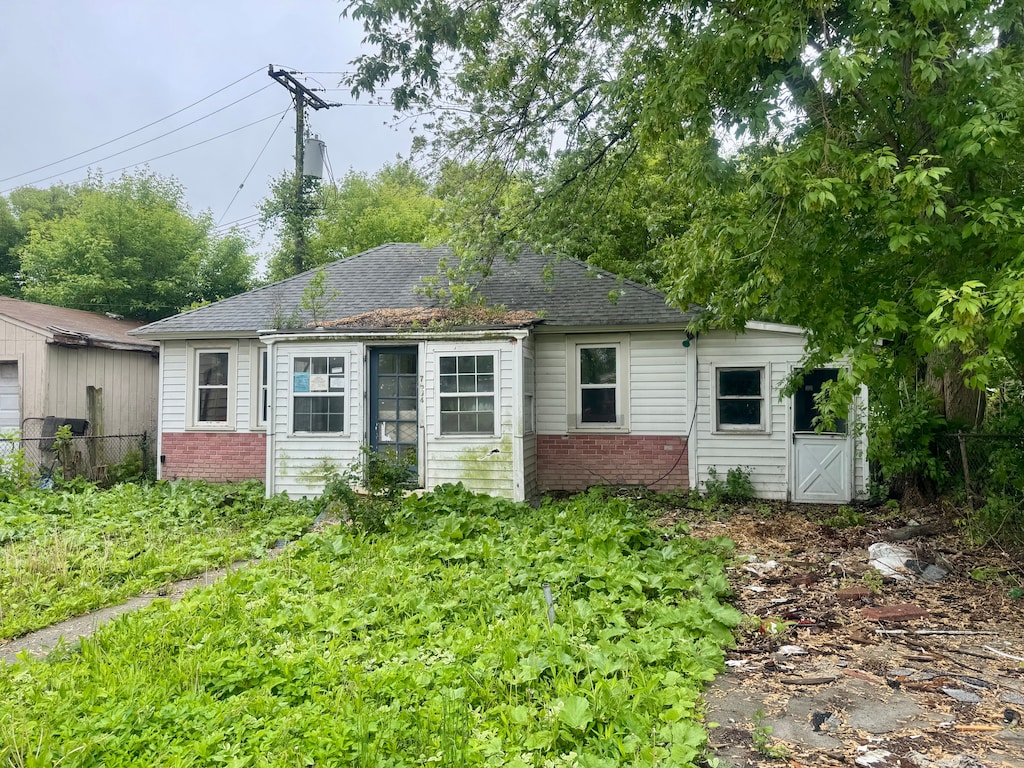 7584 Chalmers Ave, Warren, MI 48091 - view of front of home with brick siding and a shingled roof