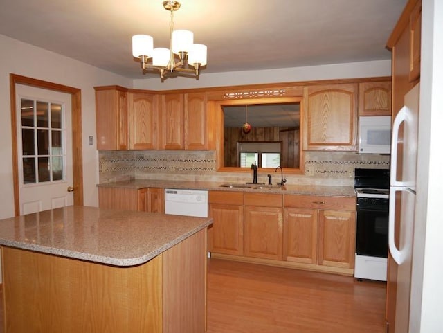 12589 Perry Rd, Battle Creek, MI 49015 - kitchen with white appliances, a sink, decorative backsplash, a chandelier, and light wood-type flooring