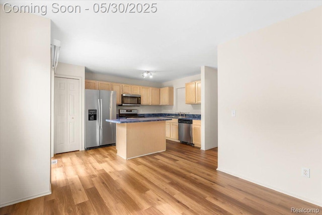 6680 Central City Pkwy, Westland, MI 48185 - kitchen featuring appliances with stainless steel finishes, light brown cabinets, light wood-type flooring, a center island, and baseboards