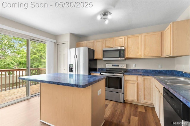 6680 Central City Pkwy, Westland, MI 48185 - kitchen featuring stainless steel appliances, light brown cabinetry, a sink, and dark countertops